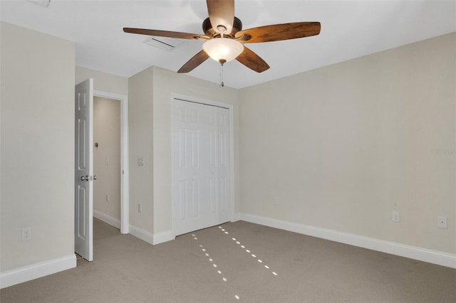 unfurnished bedroom featuring ceiling fan, carpet flooring, visible vents, baseboards, and a closet