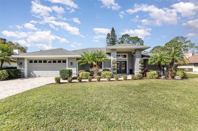 view of front of home featuring decorative driveway, french doors, an attached garage, and stucco siding