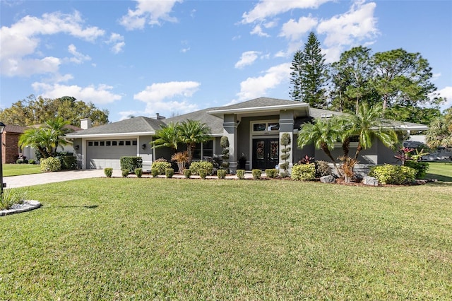 view of front facade with a garage, decorative driveway, and a front lawn