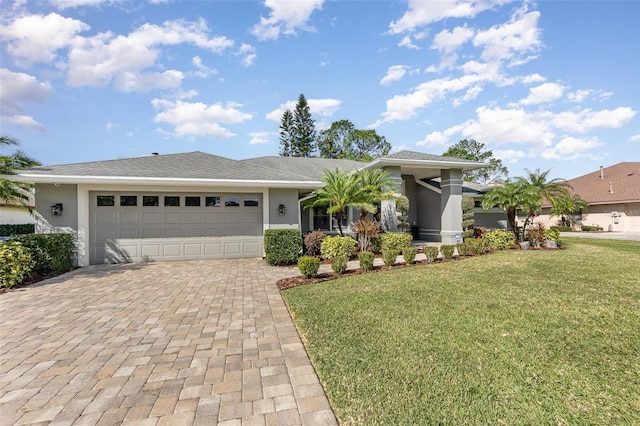 view of front of home with a garage, a front lawn, decorative driveway, and stucco siding