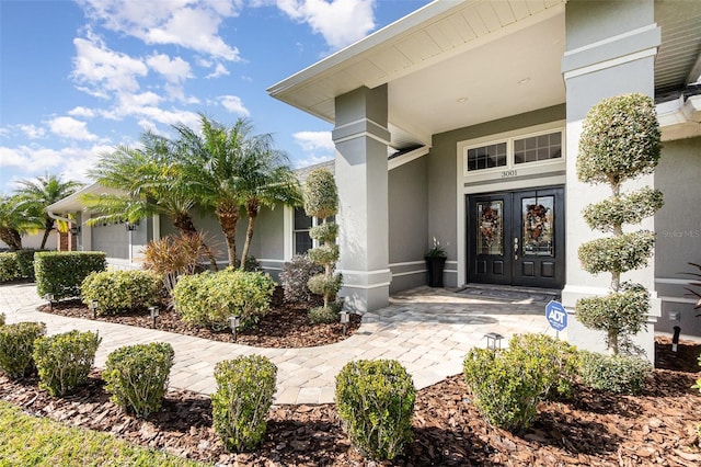 property entrance with french doors and stucco siding