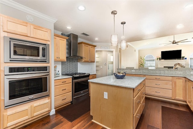 kitchen with crown molding, stainless steel appliances, light brown cabinetry, dark wood-type flooring, and wall chimney range hood