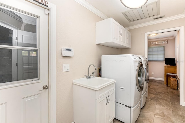 washroom with cabinet space, visible vents, independent washer and dryer, crown molding, and a sink