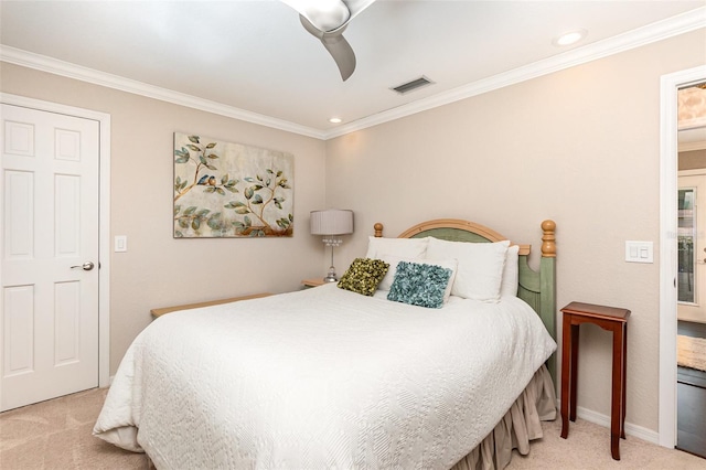 bedroom with ornamental molding, carpet flooring, visible vents, and a ceiling fan