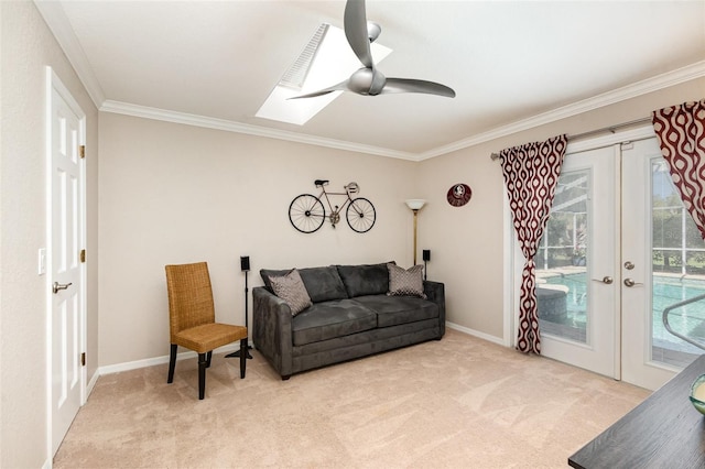 carpeted living room featuring ornamental molding, french doors, baseboards, and a ceiling fan