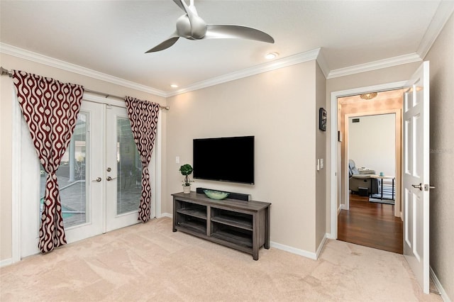 living room with ornamental molding, carpet floors, french doors, and a ceiling fan