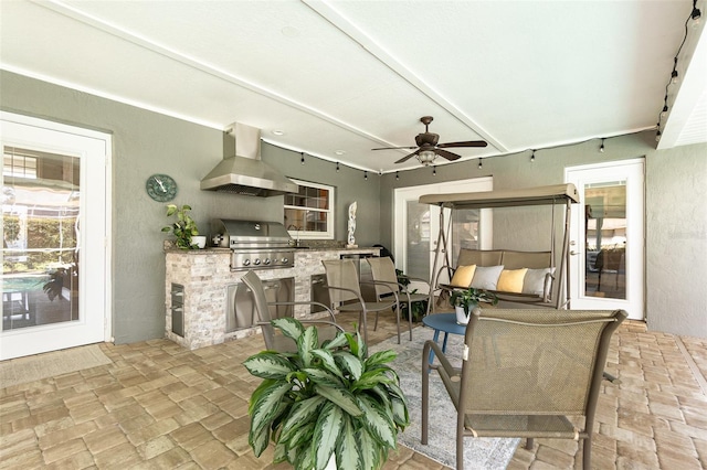 view of patio with ceiling fan, area for grilling, and a grill