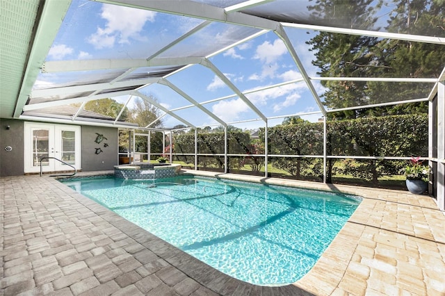 view of swimming pool with a lanai, a patio area, a pool with connected hot tub, and french doors