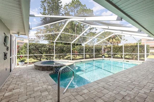 view of swimming pool featuring glass enclosure, a pool with connected hot tub, and a patio area