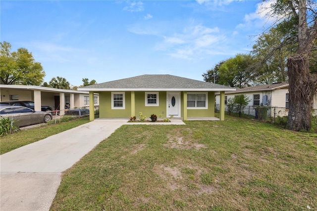 view of front facade with fence, driveway, roof with shingles, stucco siding, and a front lawn