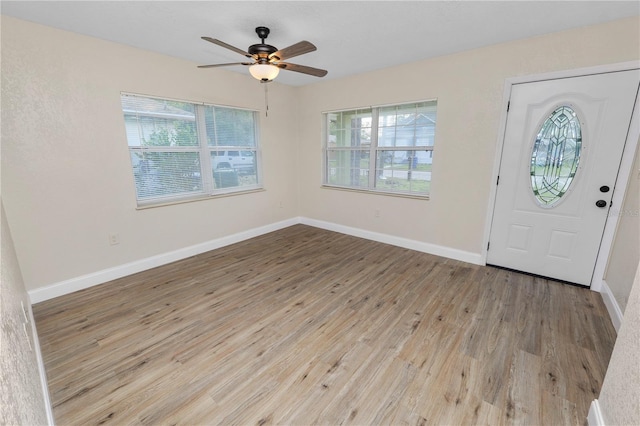 entrance foyer with ceiling fan, wood finished floors, and baseboards