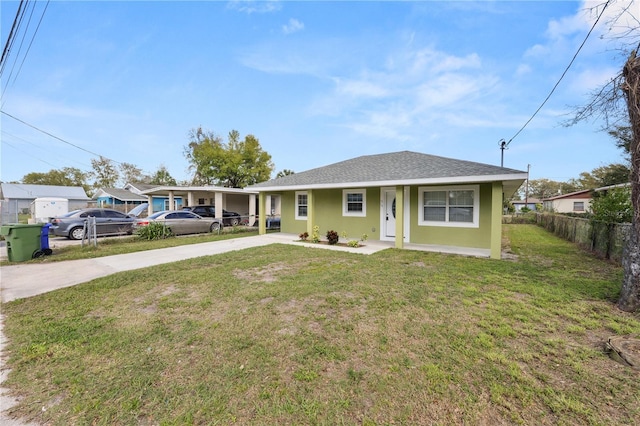 view of front of property featuring stucco siding, a shingled roof, concrete driveway, a front yard, and fence