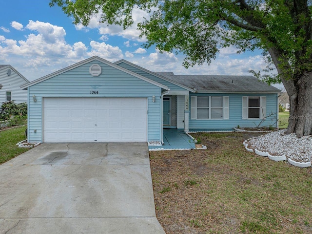 ranch-style home featuring driveway and an attached garage