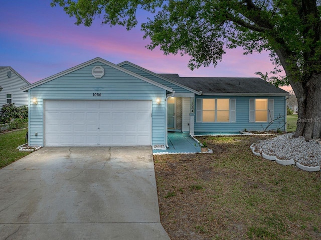 single story home featuring a garage and driveway