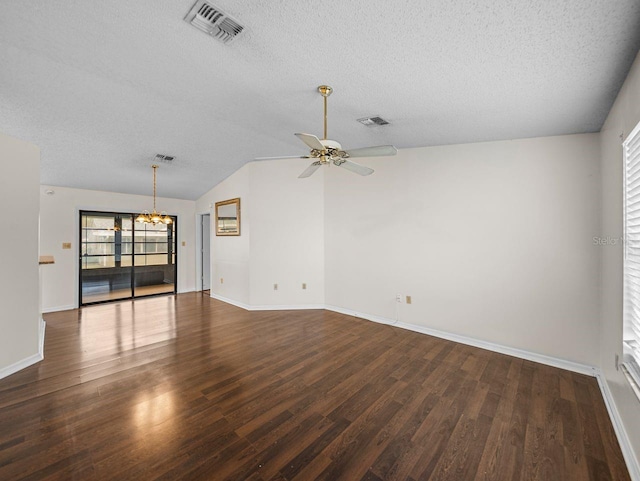 spare room with lofted ceiling, visible vents, wood finished floors, and ceiling fan with notable chandelier