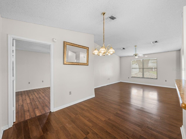 spare room with visible vents, a textured ceiling, and wood finished floors