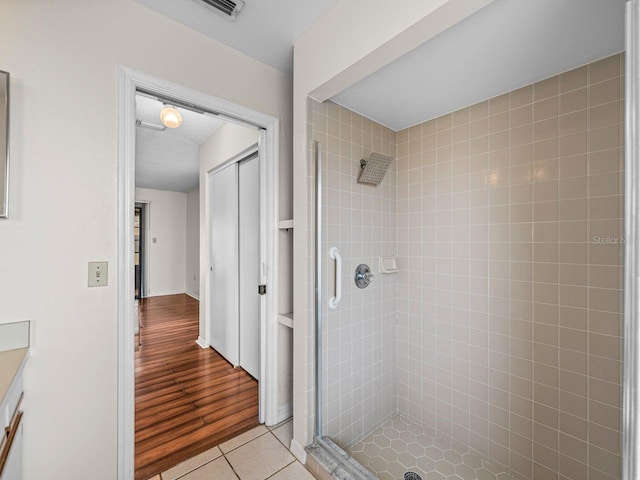 full bath featuring a stall shower, visible vents, and tile patterned floors