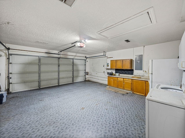 garage featuring visible vents, electric panel, washer / clothes dryer, and a garage door opener