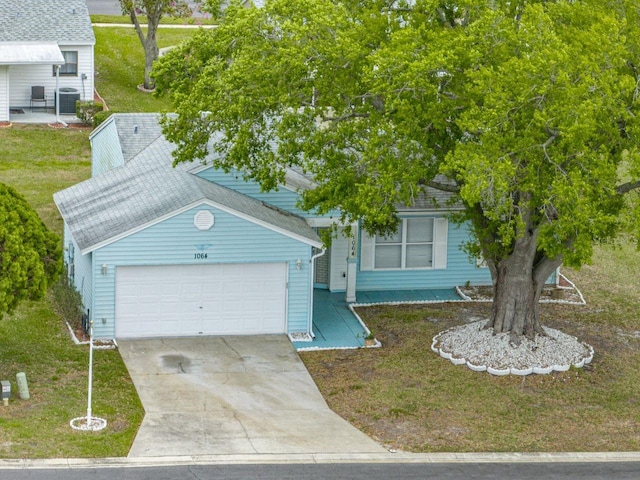 view of front of home featuring central AC unit, an attached garage, concrete driveway, roof with shingles, and a front lawn