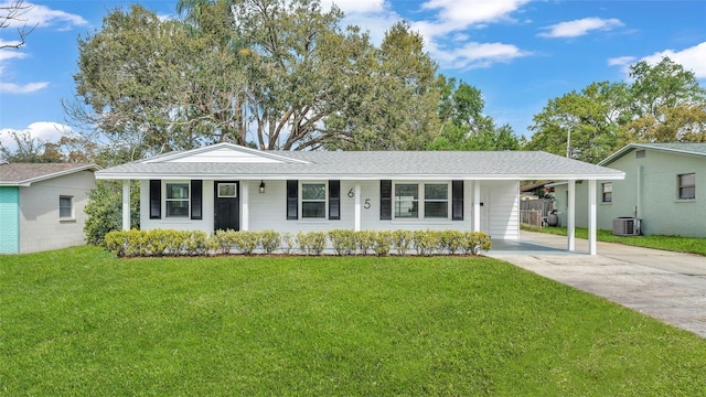 ranch-style home featuring central air condition unit, a shingled roof, a front yard, a carport, and driveway