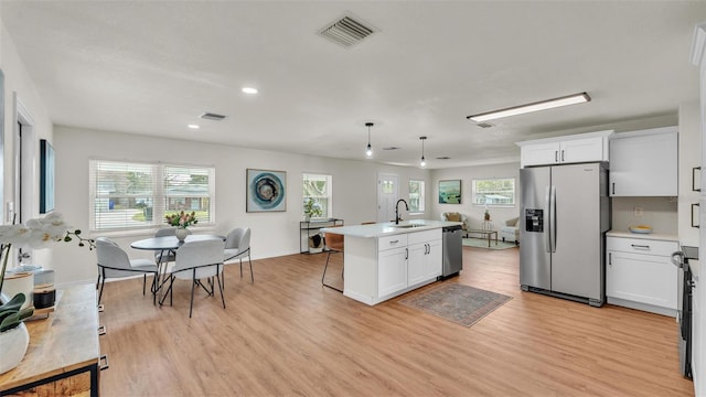 kitchen featuring appliances with stainless steel finishes, light countertops, visible vents, and white cabinetry