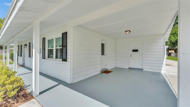 view of patio / terrace with a porch and an attached carport