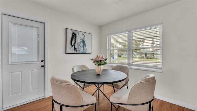 dining room with baseboards and wood finished floors