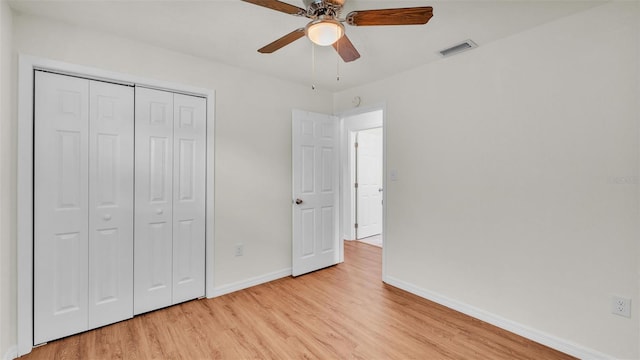 unfurnished bedroom with ceiling fan, visible vents, baseboards, a closet, and light wood-type flooring