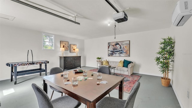 dining area with baseboards, concrete flooring, and an AC wall unit