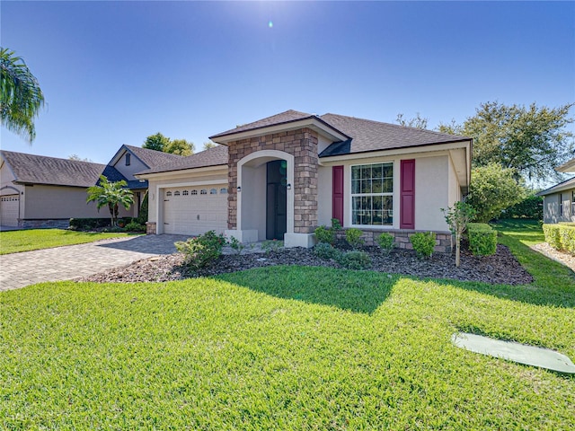 view of front of property with stucco siding, decorative driveway, stone siding, a front yard, and an attached garage