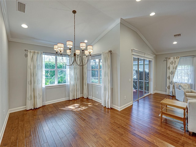 unfurnished dining area featuring vaulted ceiling, crown molding, visible vents, and wood finished floors