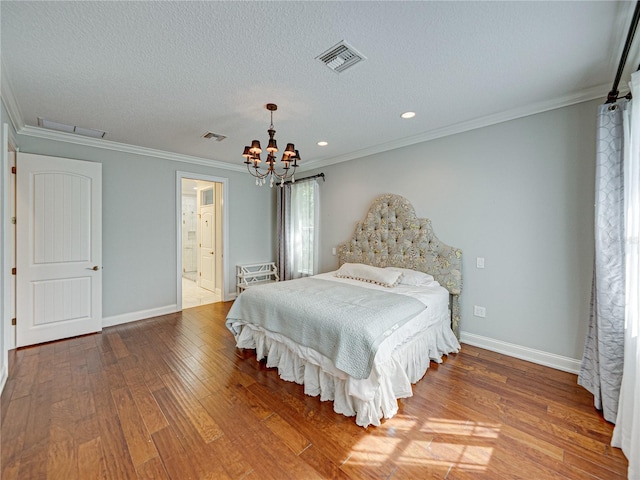 bedroom with visible vents, a textured ceiling, wood finished floors, and crown molding