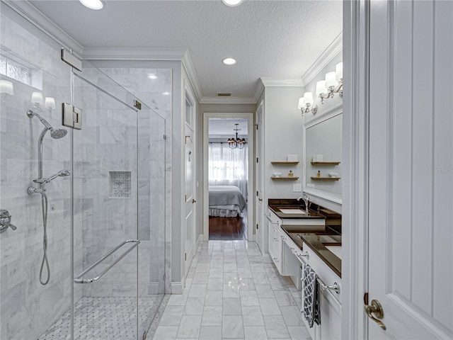 full bath with connected bathroom, a textured ceiling, a stall shower, and crown molding