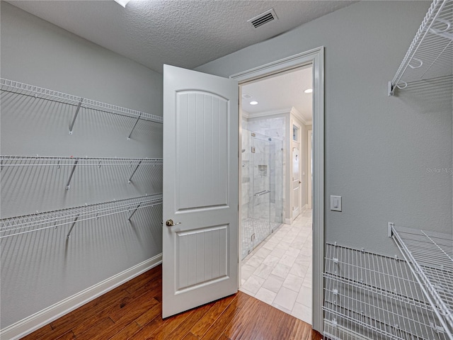 spacious closet with visible vents and wood finished floors