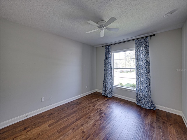 unfurnished room with a textured ceiling, a ceiling fan, baseboards, and wood finished floors