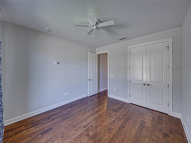 unfurnished bedroom with visible vents, baseboards, a closet, and wood finished floors