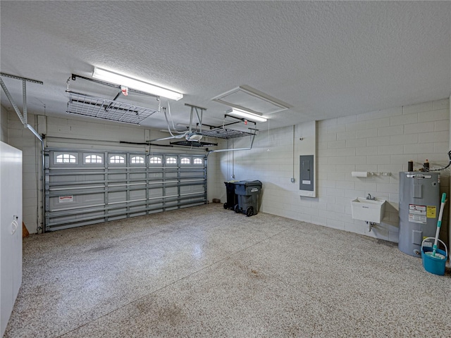 garage featuring electric panel, electric water heater, a garage door opener, and concrete block wall