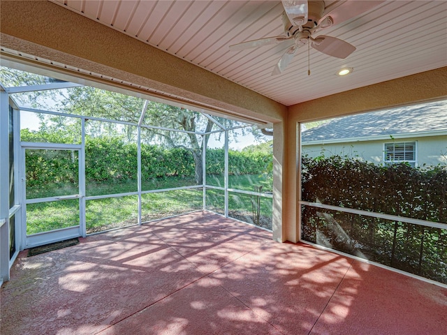 unfurnished sunroom with ceiling fan