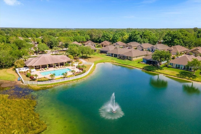 drone / aerial view featuring a forest view and a water view