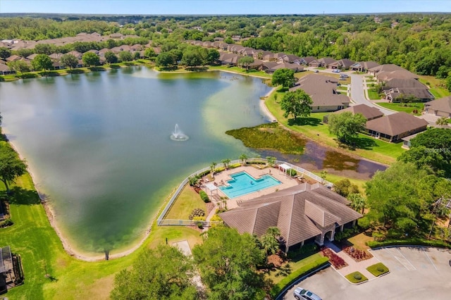 bird's eye view featuring a residential view, a wooded view, and a water view