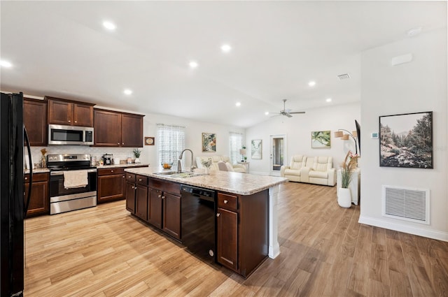 kitchen featuring visible vents, dark brown cabinets, light wood-type flooring, black appliances, and a sink