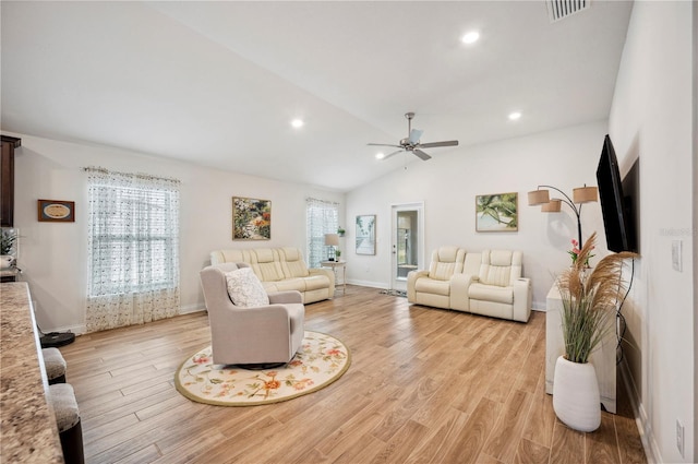 living room with light wood-type flooring, visible vents, vaulted ceiling, and recessed lighting