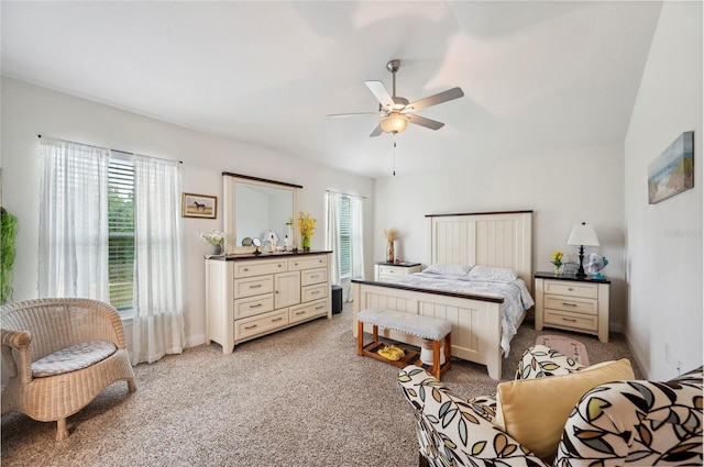 bedroom with a ceiling fan and light colored carpet