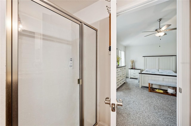 bathroom featuring ceiling fan, a shower stall, and ensuite bath