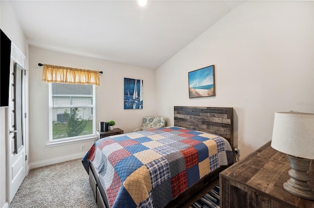 carpeted bedroom featuring baseboards and vaulted ceiling