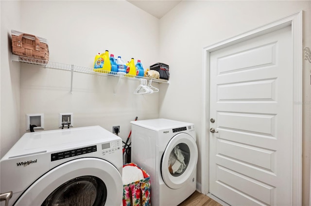 laundry area featuring laundry area, washer and clothes dryer, and light wood-type flooring