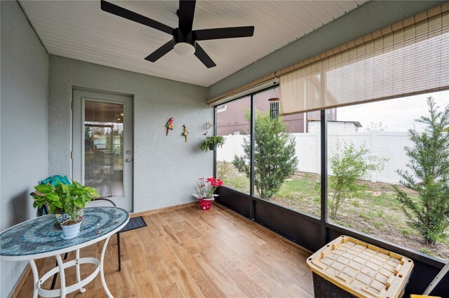 sunroom / solarium featuring ceiling fan