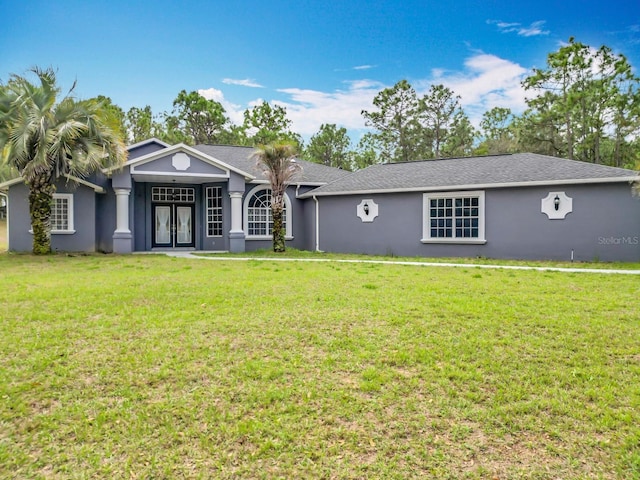 single story home featuring stucco siding, french doors, and a front yard