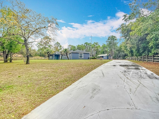 view of front of house with a front yard and fence