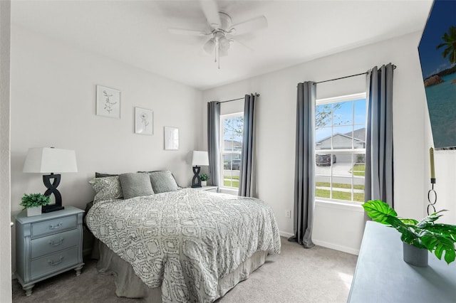 carpeted bedroom featuring ceiling fan and baseboards